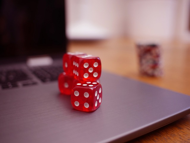 Laptop and dice to represent online gambling